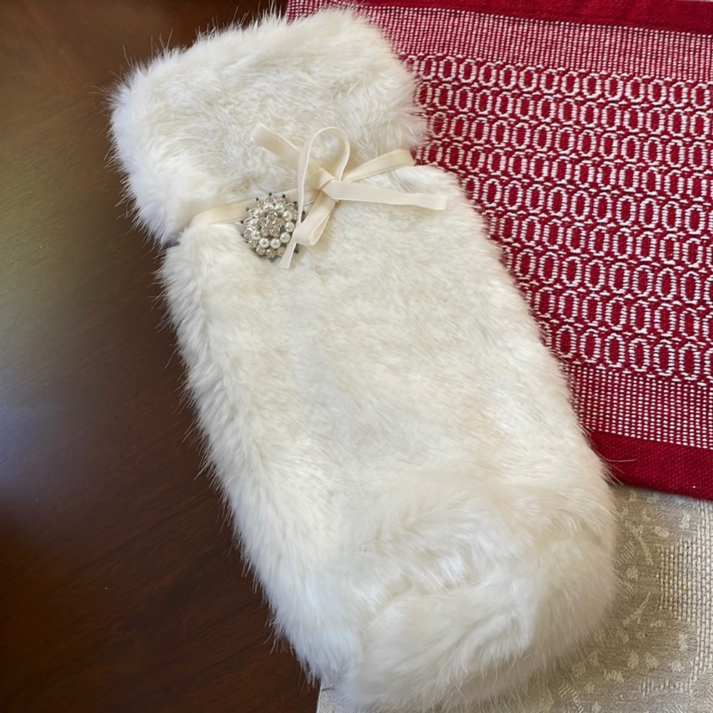 White faux fur bag sack with velvet ribbon and crystal pin button